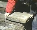 Laying the capping stone with the hammered down corners