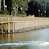 Freedraining retaining wall systems for shoreline protection